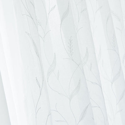 Kirjailtu valoverho ohuella kasvi-kuviolla