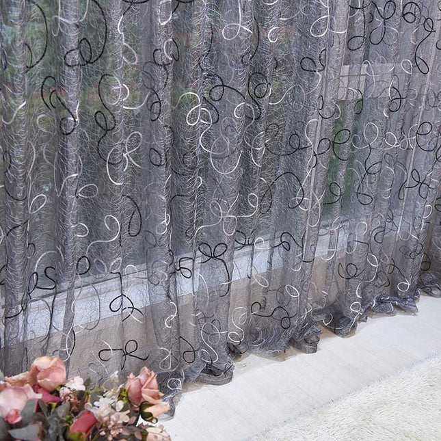 Harmaa valoverho koristeellisella kirjailulla