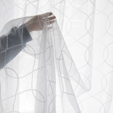 Valkoinen valoverho geometrisella kuviolla