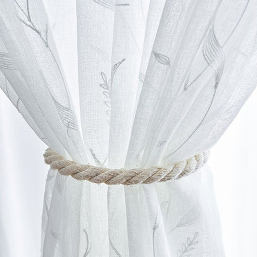 Kirjailtu valoverho ohuella kasvi-kuviolla