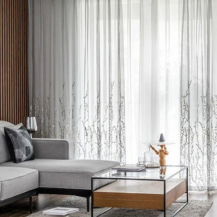 Läpikuultava verho kirjaillulla oksakuviolla