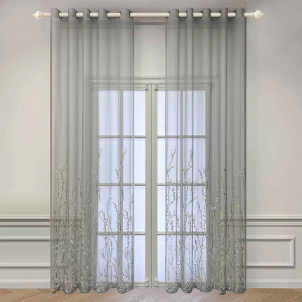 Läpikuultava verho kirjaillulla oksakuviolla