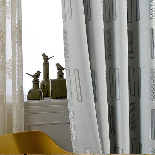 Harmaa pimennysverho graafisella kuviolla